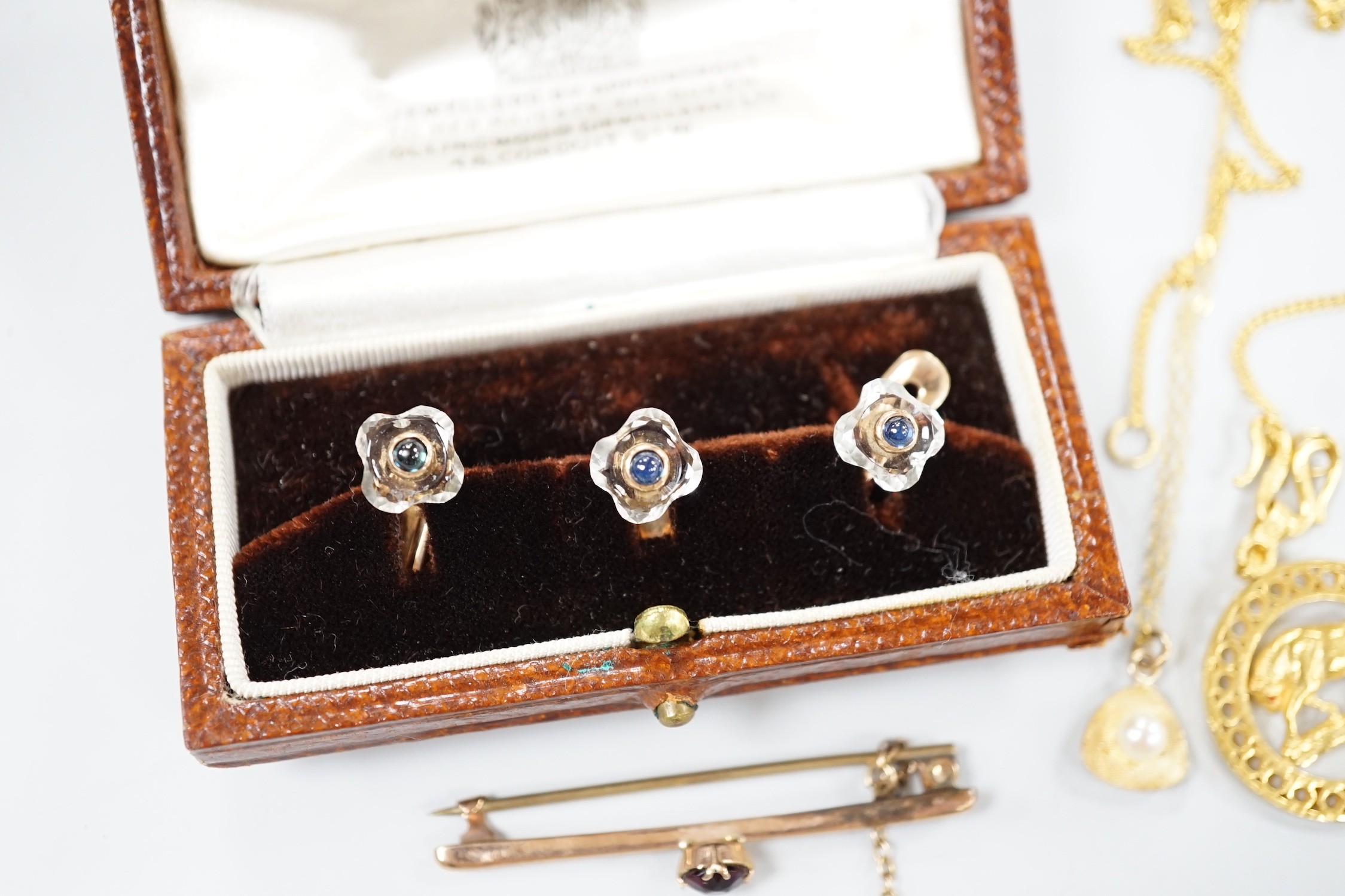 A small collection of jewellery to include a yellow metal Taurus medallion, a small yellow metal and gem set bar brooch, a 9ct gold and cultured pearl pendant and an Austro Hungarian yellow metal, paste and cabochon set